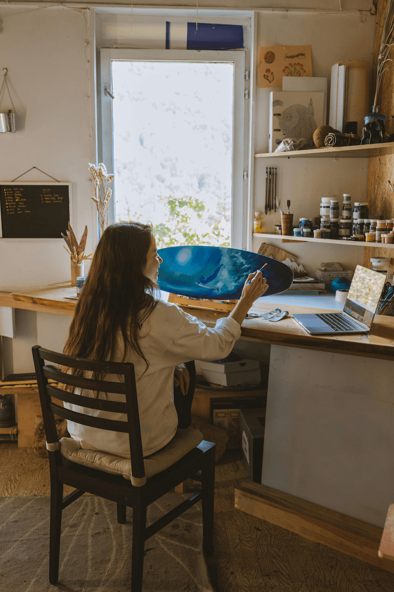 Girl in art studio with laptop